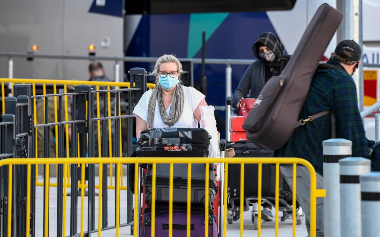 Passengers wearing facemasks arrive at Sydney International Airport off a Qatar Airways flight on May 1 - James D. Morgan /Getty Images AsiaPac 