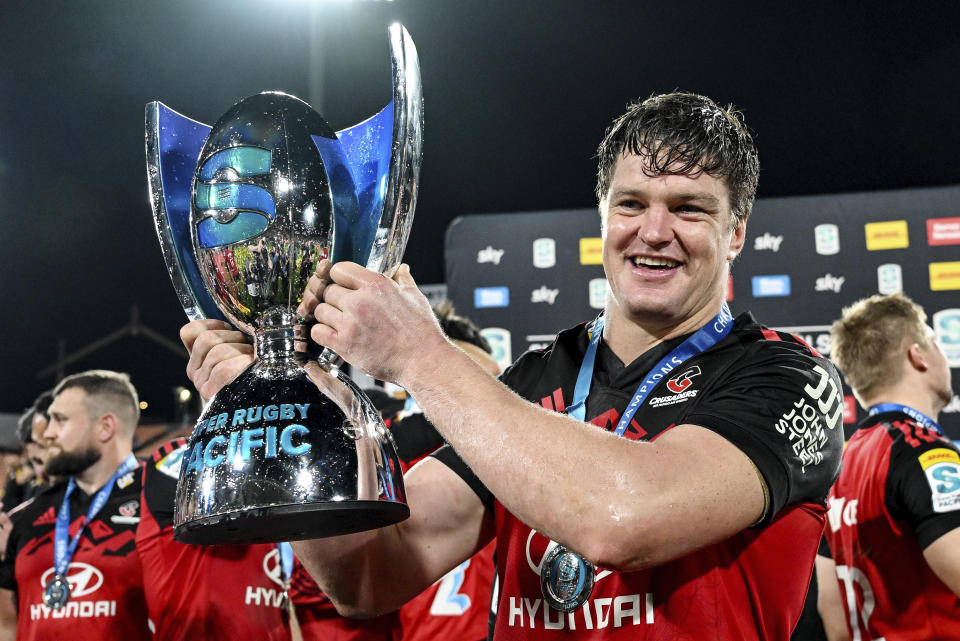 Crusaders captain Scott Barrett holds the trophy aloft after defeating the chiefs in the Super Rugby Pacific final in Hamilton, New Zealand, Saturday, June 24, 2023. (Andrew Cornaga/Photosport via AP)