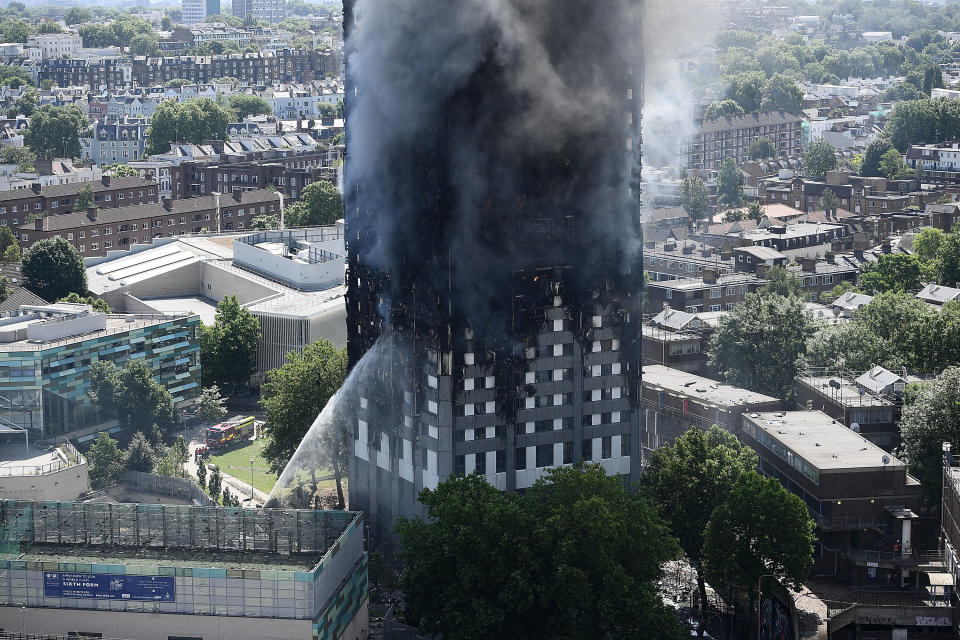 LONDON, ENGLAND - JUNE 14:  Fire fighters drench the burning 24 storey residential Grenfell Tower block in Latimer Road, West London on June 14, 2017 in London, England.  The Mayor of London, Sadiq Khan, has declared the fire a major incident as more than 200 firefighters are still tackling the blaze while at least 50 people are receiving hospital treatment.  (Photo by Carl Court/Getty Images)
