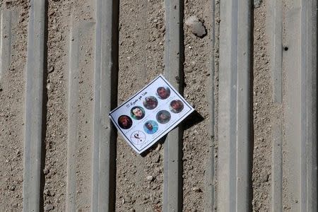 One of the warning leaflets dropped by the Syrian army is seen in the rebel held Tariq al-Bab neighbourhood of Aleppo, Syria September 25, 2016. The leaflet reads (top) "This is your destiny!!!" and (bottom L) " who is next" as it depicts pictures of killed rebel commanders and fighters. REUTERS/Abdalrhman Ismail