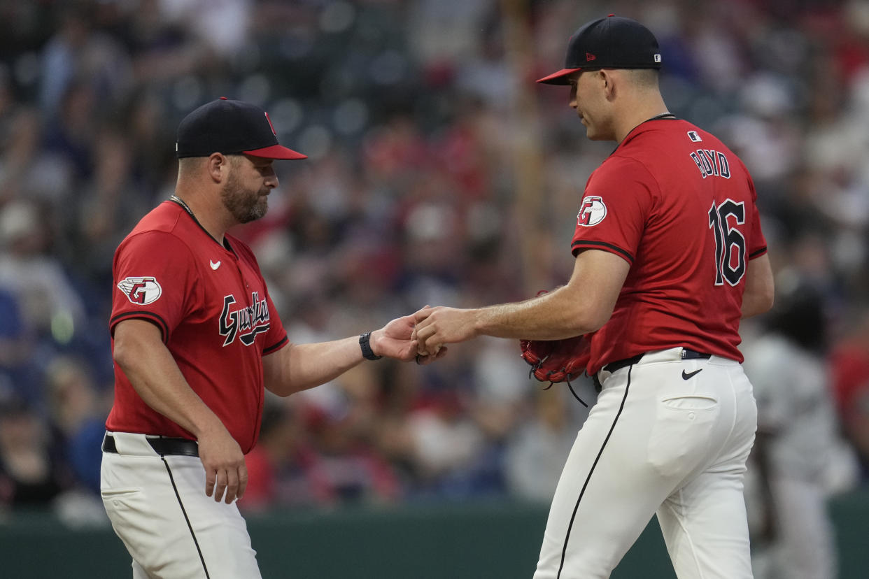 Cleveland Guardians starting pitcher Matthew Boyd (16) is taken out by manager Stephen Vogt, left, in the third inning of a baseball game against the Minnesota Twins, Monday, Sept. 16, 2024, in Cleveland. (AP Photo/Sue Ogrocki)