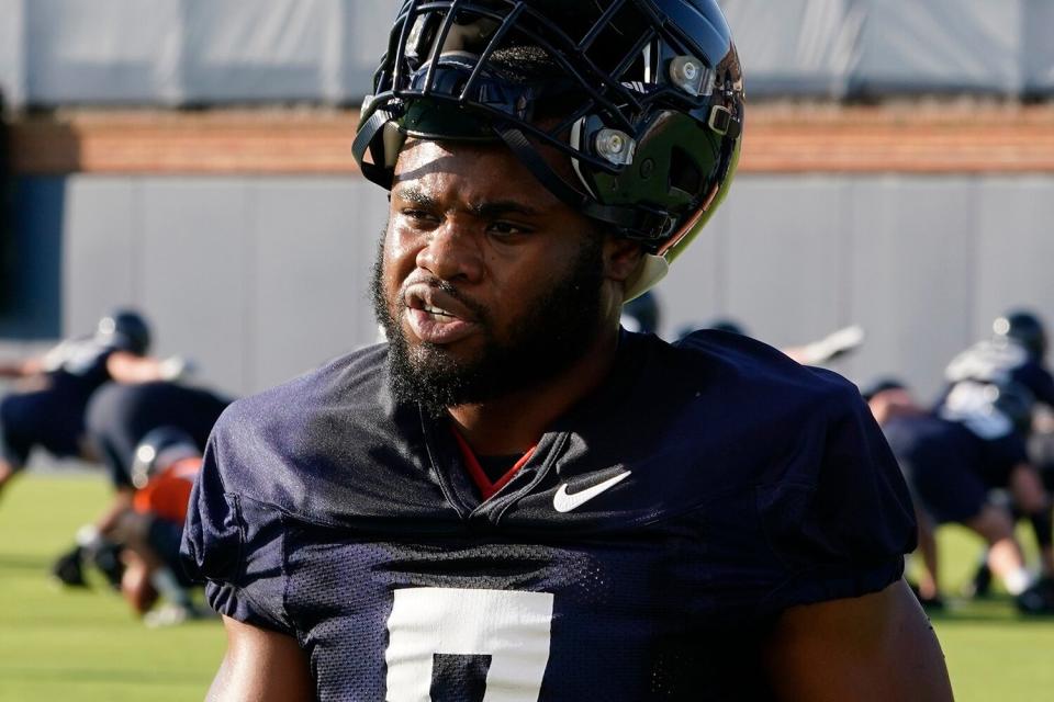 Virginia running back Mike Hollins takes a break during NCAA college football practice, in Charlottesville, Va.