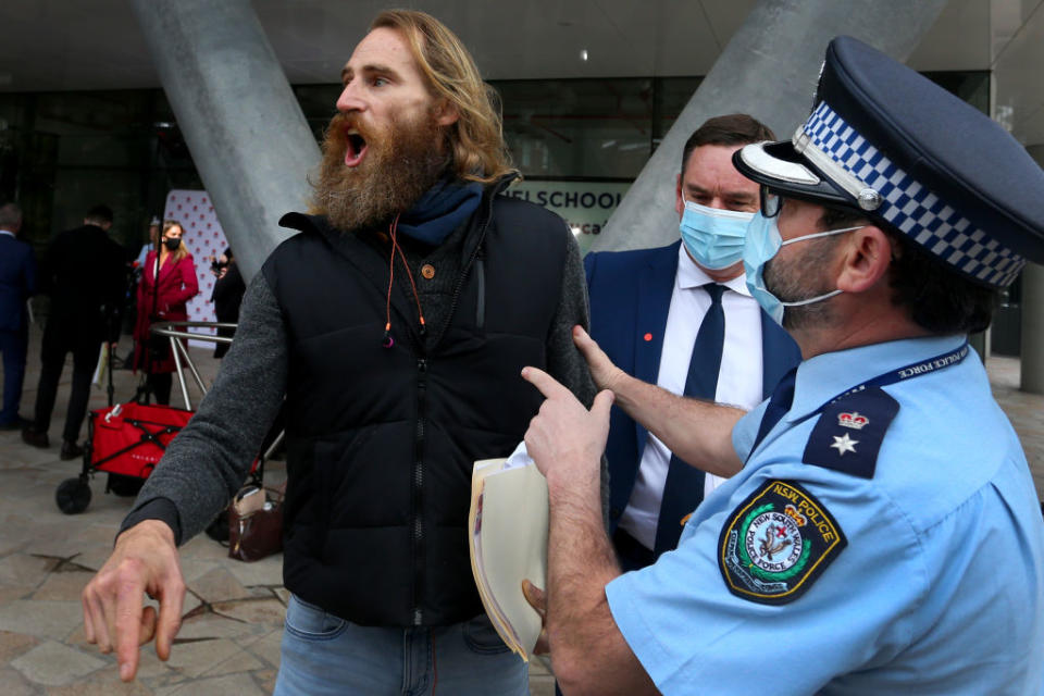 The protester was walked away by police but was let go soon after. Source: Getty