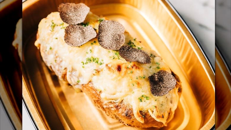 Twice baked potato with melted cheese and shaved black truffle