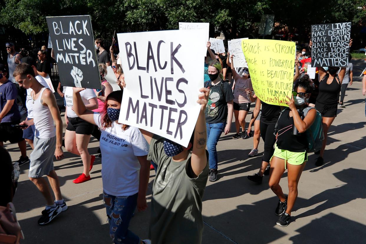 Several hundred demonstrators march peacefully as they protest in Addison, Texas, Thursday, June 4, 2020. Protests continued following the death of George Floyd, who died after being restrained by Minneapolis police officers on May 25. (AP Photo/Tony Gutierrez)
