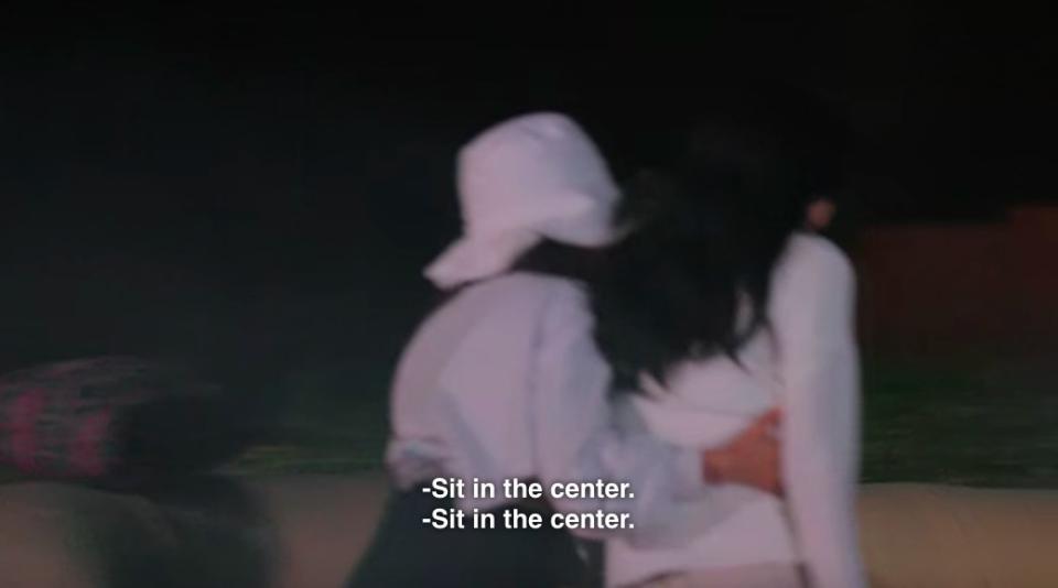 Yea-won pushes Su-min towards the campfire ans says "Sit in the center"