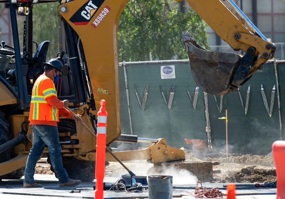 Construction workers wearing face masks, work around the new stadium in Inglewood amid the stay-at-home orders during the Covid-19 pandemic, April 27, 2020, in Inglewood, California. (Photo by VALERIE MACON / AFP) (Photo by VALERIE MACON/AFP via Getty Images)