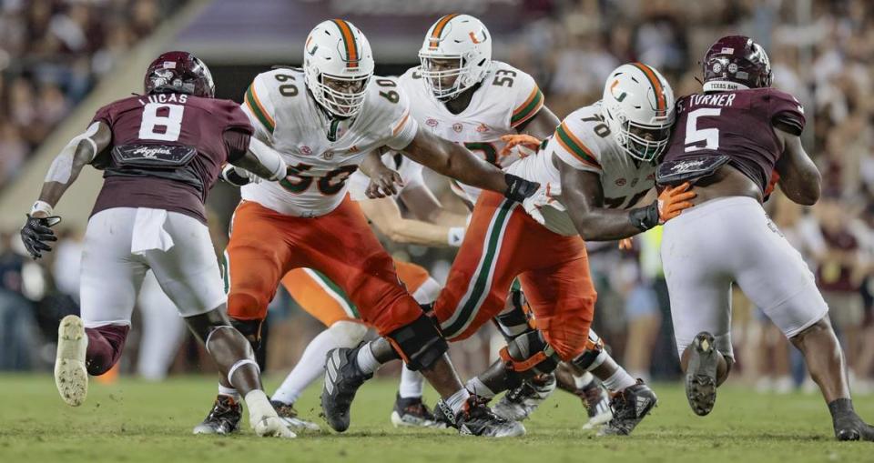 Miami Hurricanes offensive lineman Zion Nelson (60), Jakai Clark (53) and Justice Oluwaseun (70) battle the Texas A&M Aggies defense as they protect quarterback Tyler Van Dyke (9) in the second half at Kyle Field, Bryan College Station, Texas on Saturday, September 17, 2022.