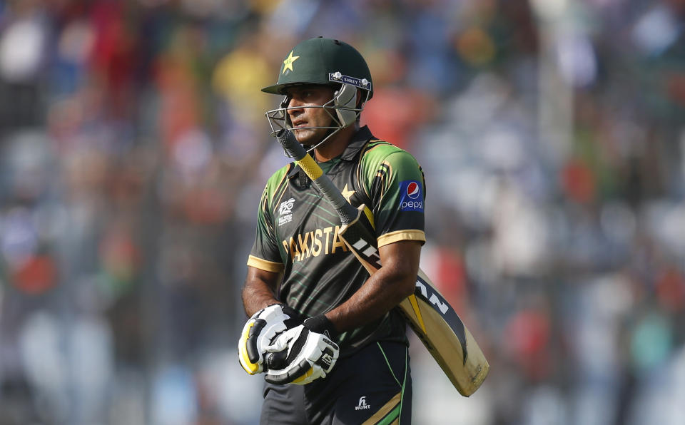 Pakistan captain Mohammad Hafeez leaves the ground after losing his wicket during their ICC Twenty20 Cricket World Cup match against Bangladesh in Dhaka, Bangladesh, Sunday, March 30, 2014. (AP Photo/Aijaz Rahi)