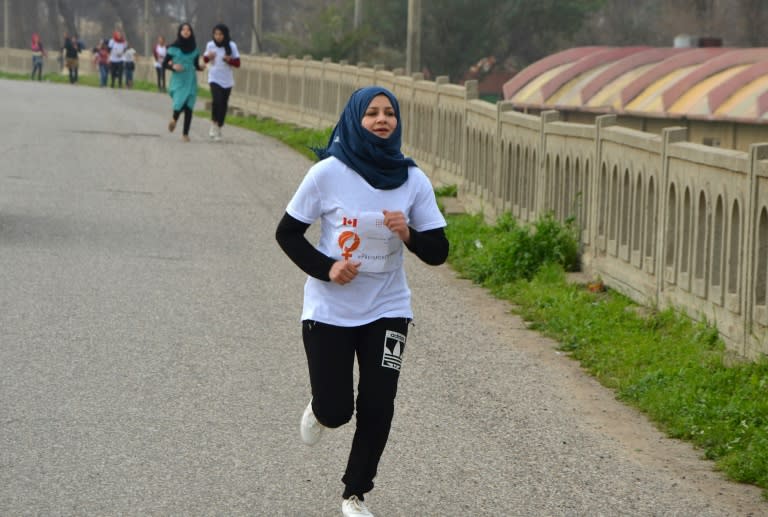 Iraqi women take part in a symbolic 900-metre marathon on March 8, 2018, to mark International Women's Day in Mosul, eight months after Iraqi forces retook the northern city from Islamic State group jihadists
