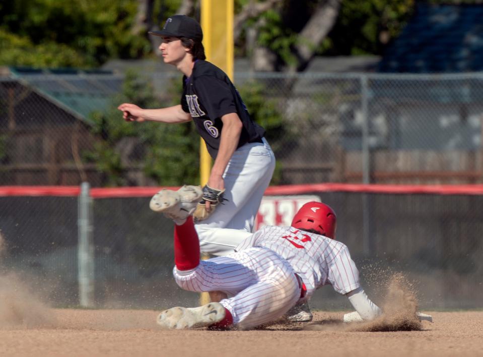 Lincoln's Diego Davis slides safely at second as Tokay's Ryan Oliveri waits for the throw during a varsity baseball game at Lincoln in Stockton on Wednesday, Apr.19, 2023.