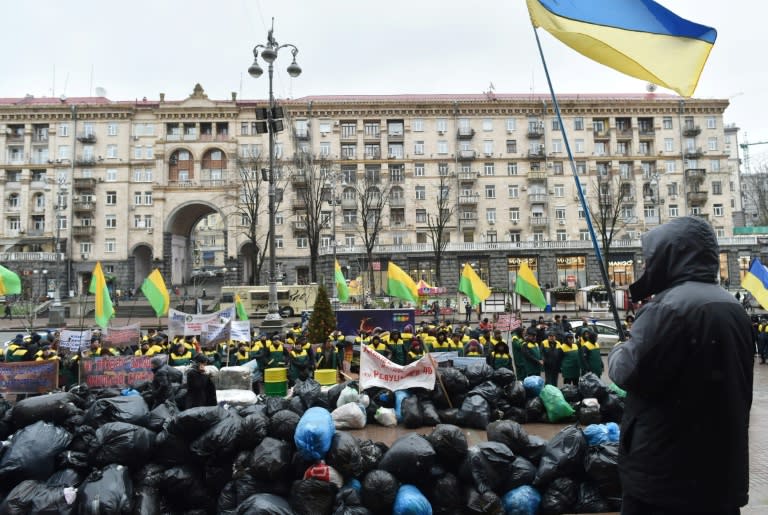 Community workers demonstrate with garbage bags at City Hall in Kiev on December 20, 2016 to oppose a city development