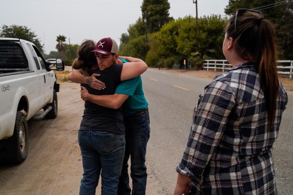 Jarad Jennings hugs his mother-in-law, Gabrielle Kant, as Gabrielle's daughter Emily Jennings looks on.