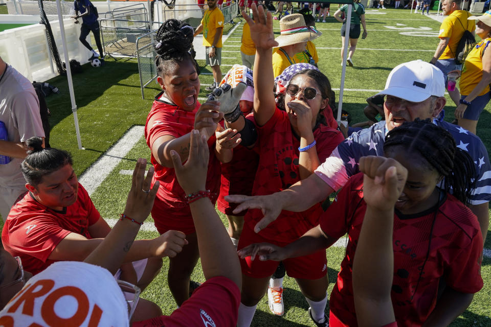 Yuli Pineda, center right, leads the U.S. women's team in a chant before a match at the Homeless World Cup, Tuesday, July 11, 2023, in Sacramento, Calif. (AP Photo/Godofredo A. Vásquez)