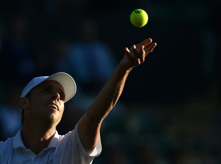 US player Sam Querrey serves to Serbia's Novak Djokovic during their men's singles third round match at Wimbledon on July 1, 2016