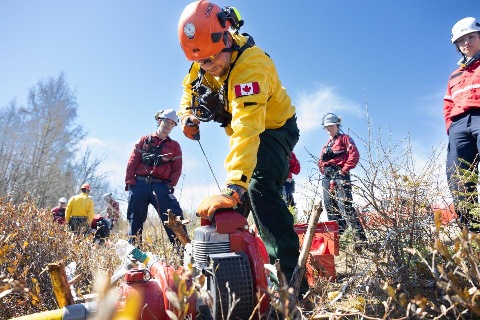 A Canadian Army firefighter practices using a motor-driven pump at the Valcartier military base in Saint-Gabriel-de-Valcartier near Quebec City on May 1.  He's training with the nonprofit  Societe de protection des forets contre le feu, which is increasing its firefighting workforce.