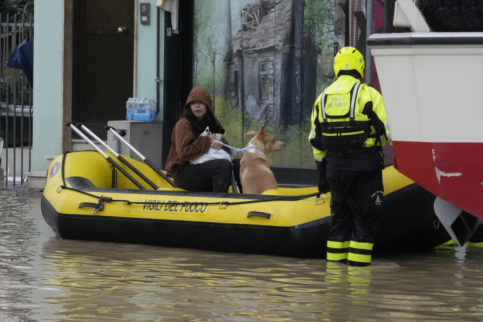 Firefighters rescue a resident in Campi di Bisenzio, in the central Italian Tuscany region, Friday, Nov. 3, 2023. Record-breaking rain provoked floods in a vast swath of Tuscany as storm Ciaran pushed into Italy overnight Friday, trapping people in their homes, inundating hospitals and overturning cars. At least three people were killed, and four were missing. (AP Photo/Gregorio Borgia)