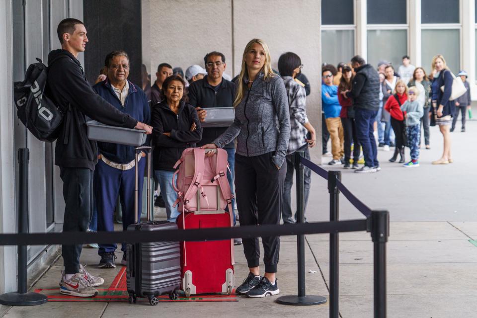 Marni Larsen and her son, Damon Rasmussen of Holladay, Utah, wait their turn in line hoping to snag her son's passport outside the Los Angeles Passport Agency at the Federal Building in Los Angeles on June 14, 2023.  Larsen applied for her son's passport two months earlier.