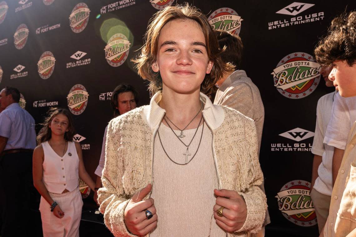 Actors Michael Cash, who plays Young Robert Ratliff, shows off his outfit on the red carpet for the world premiere of the movie “You Gotta Believe” outside of the AMC Palace 9 Theatre in downtown Fort Worth on Thursday, Aug. 29, 2024.