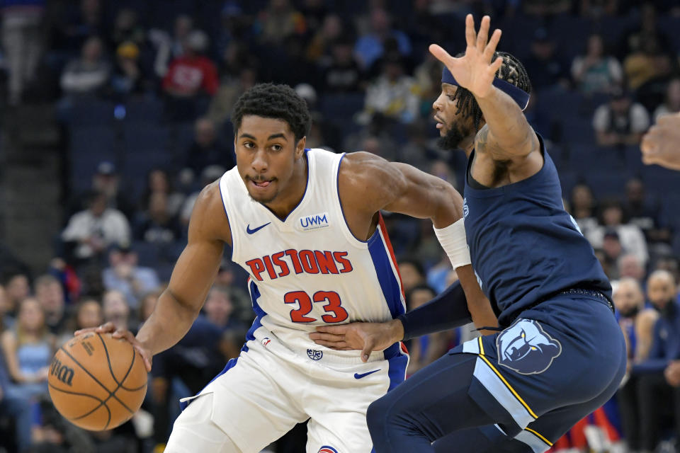 Detroit Pistons guard Jaden Ivey (23) handles the ball against Memphis Grizzlies forward Lamar Stevens in the first half of an NBA basketball game Friday, April 5, 2024, in Memphis, Tenn. (AP Photo/Brandon Dill)