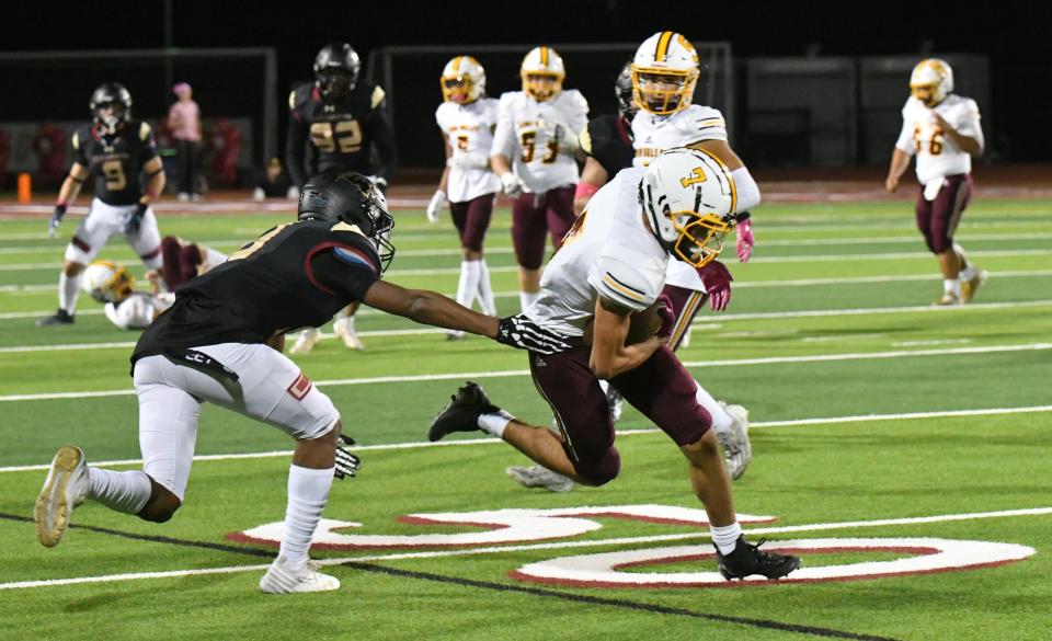 Simi Valley's Dominic DeMaio tries to get away from an Oaks Christian defender during a Marmonte League game on Oct. 20.