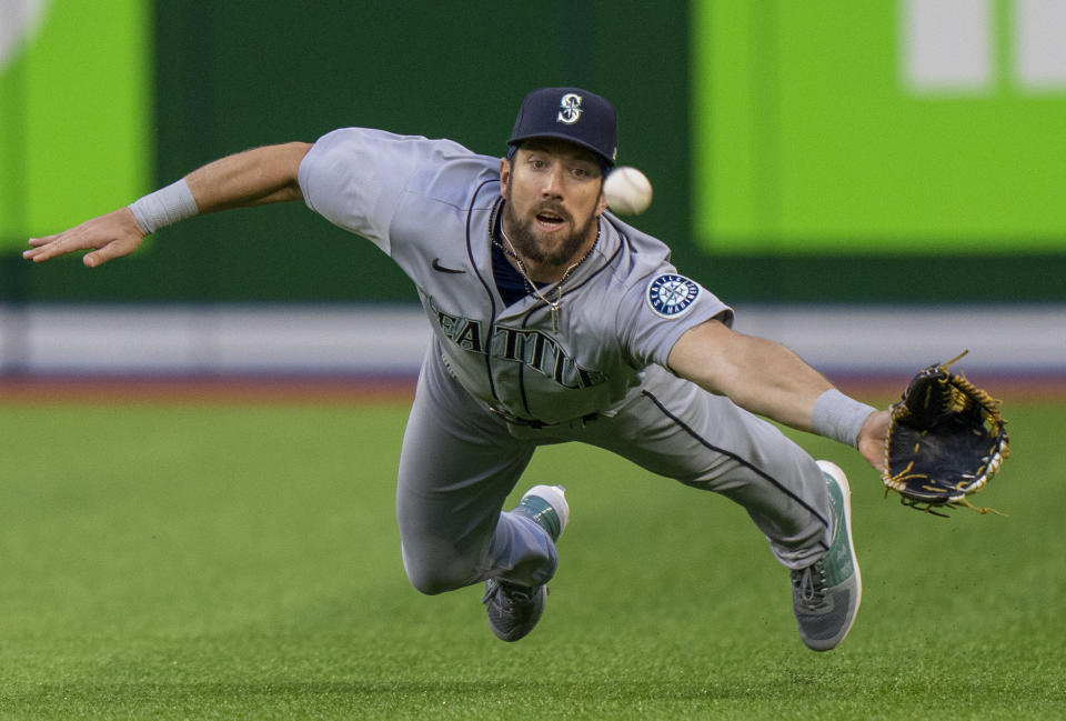 Seattle Mariners right fielder Steven Souza Jr. dives to try to catch a ball hit by Toronto Blue Jays' George Springer for a three-run triple during the second inning of a baseball game Tuesday, May 17, 2022, in Toronto. (Frank Gunn/The Canadian Press via AP)