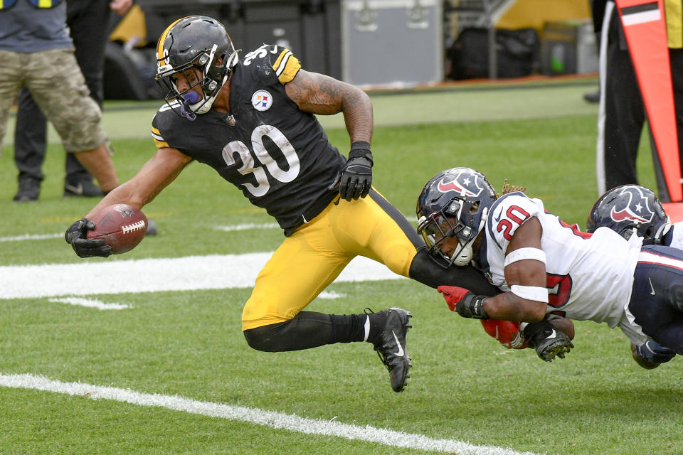 Pittsburgh Steelers running back James Conner (30) stretches for the end zone to score as Houston Texans strong safety Justin Reid (20) tries to bring him down in the second half of an NFL football game, Sunday, Sept. 27, 2020, in Pittsburgh. (AP Photo/Don Wright)