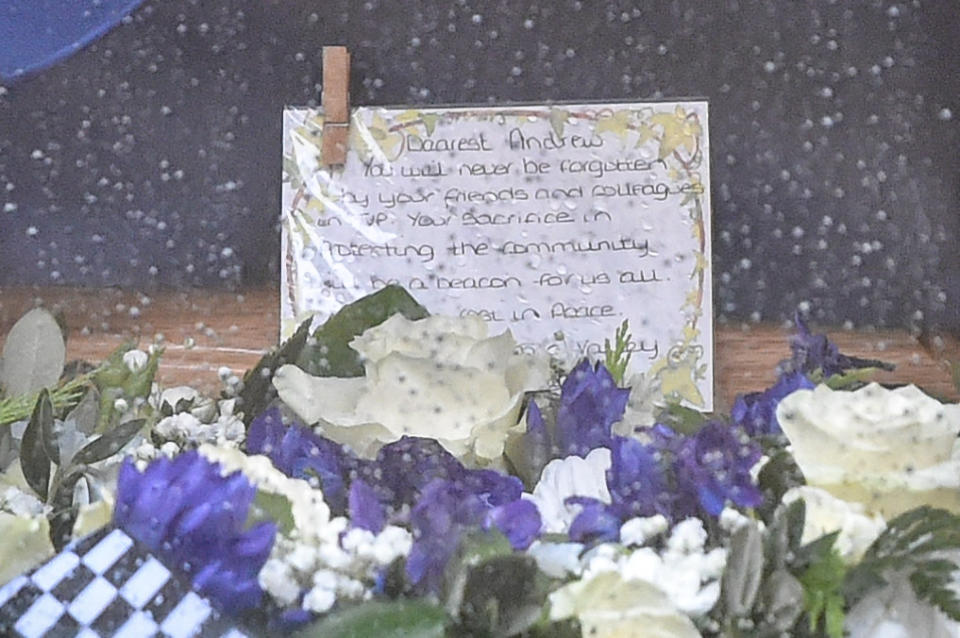 "You will never be forgotten": A note written by Pc Harper's colleagues is placed on the coffin. (PA)