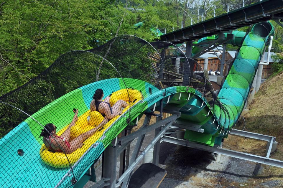 FILE -- In this May 10, 2013 file photo, visitors try out the new RiverRush ride at Dollywood theme park in Pigeon Forge, Tenn. The park plans to open DreamMore Resort in 2015 as part of a planned $300 million expansion to take place over the next decade. The resort hotel has been Dolly Parton's dream ever since she affixed her name to the theme park 28 years ago. (AP Photo/The Knoxville News Sentinel, Paul Efird, File)