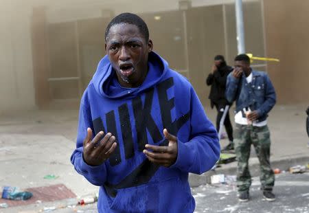 A demonstrator looks up after being sprayed with pepper spray during clashes in Baltimore, Maryland April 27, 2015. REUTERS/Shannon Stapleton