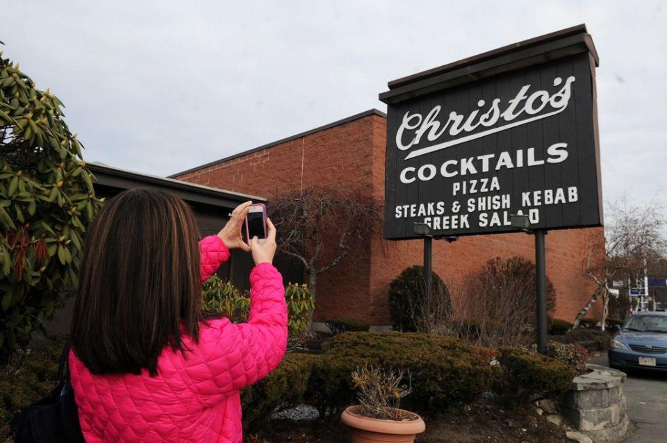 Karen Strollo, of Locust Grove, Virigina, originally of Brockton, photographs the sign at Christo's restaurant in Brockton, on Friday, Dec. 27, 2013.