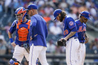 New York Mets starting pitcher Trevor Williams (29) stands on the mound after a meeting following a solo home run by Texas Rangers' Kole Calhoun in the fourth inning of a baseball game, Saturday, July 2, 2022, in New York. (AP Photo/John Minchillo)