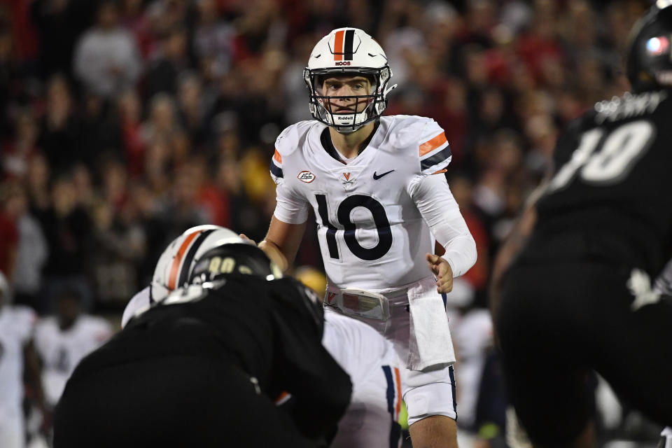 Virginia quarterback Anthony Colandrea (10) prepares to take a snap during the second half of an NCAA college football game against Louisville in Louisville, Ky., Thursday, Nov. 9, 2023. (AP Photo/Timothy D. Easley)