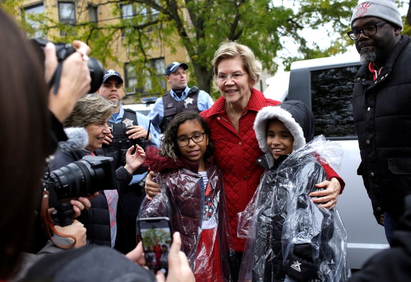 Democratic presidential candidate Senator Elizabeth Warren takes a photo with some students as she visits a picket line of striking teachers in Chicago