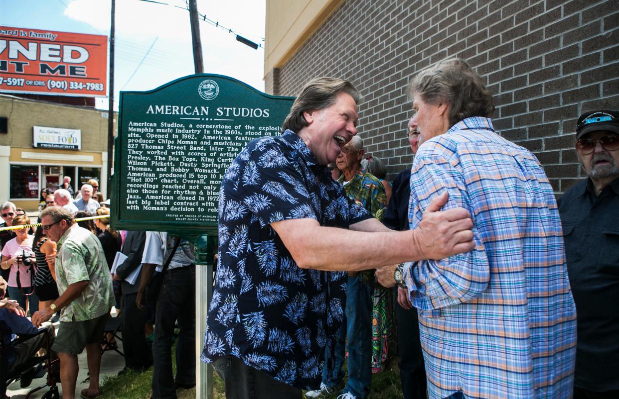 Songwriter Mark James, who penned Elvis Presley's hit "Suspicious Minds", embraces Reggie Young, guitarist of the American Sound Studios band The Memphis Boys, during the unveiling of the American Studios historical marker at 831 Thomas in 2014.