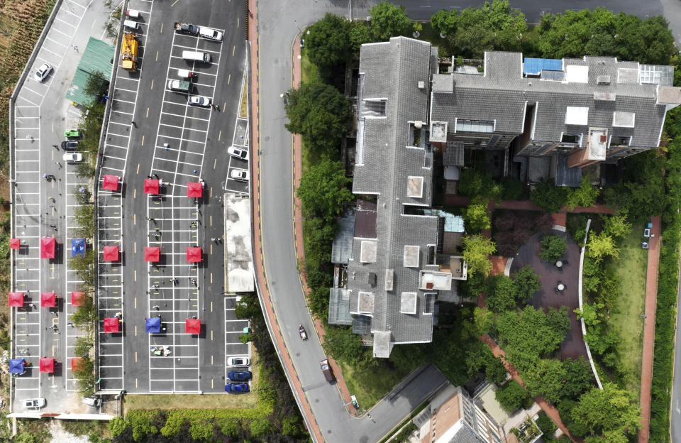 Aerial photo shows a community testing site for COVID-19 in Wudang District of Guiyang, southwest China's Guizhou Province, Sept. 5, 2022. In the city of Guiyang, in mountainous southern Guizhou province, a zoo put out a call for help last week, asking for pork, chicken, apples, watermelons, carrots and other produce out of concern they could run out of food for their animals. (Yang Ying/Xinhua via AP)