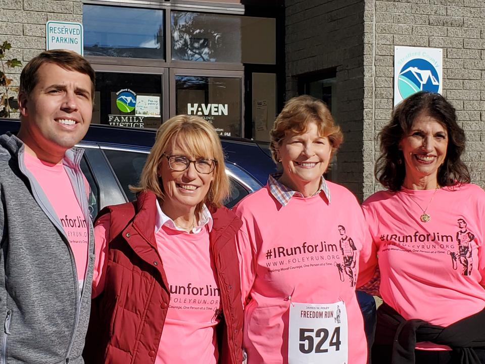 Rep. Chris Pappas, left, Sen. Maggie Hassan, Sen. Jeanne Shaheen and Diane Foley share a moment together at the eighth annual James Foley Freedom Run in Rochester Saturday, Oct. 15, 2022.