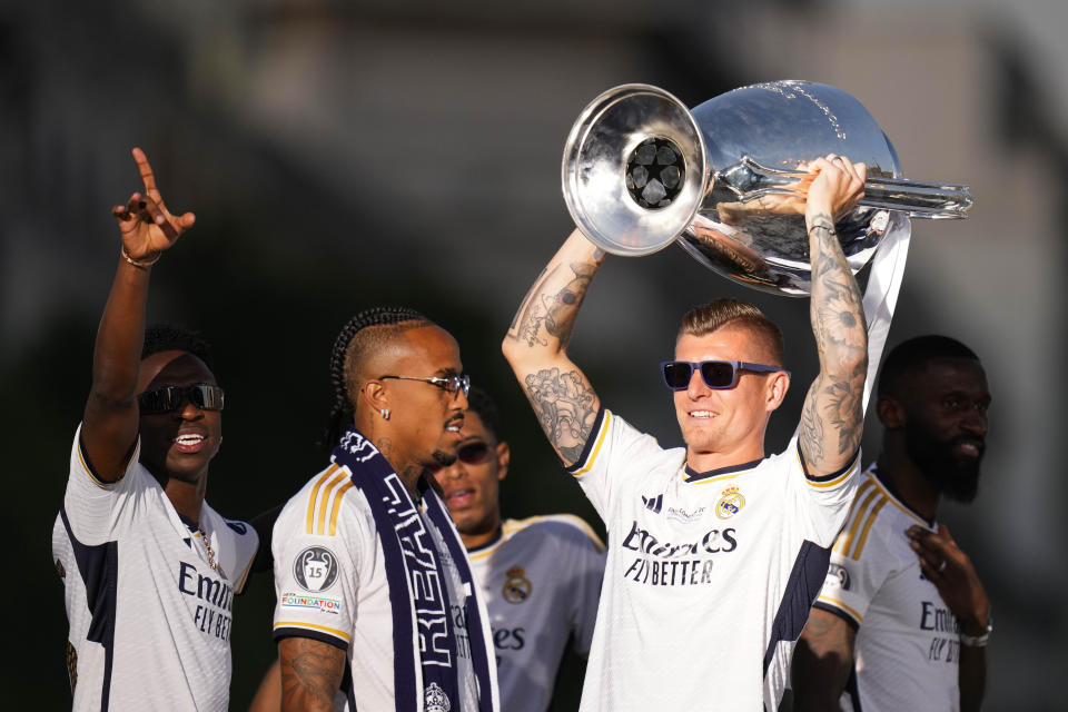 Real Madrid's Toni Kroos holds the Champions League trophy at the Cibeles square during a trophy parade in Madrid, Spain, Sunday, June 2, 2024. Real Madrid won against Borussia Dortmund 2-0. (AP Photo/Bernat Armangue)