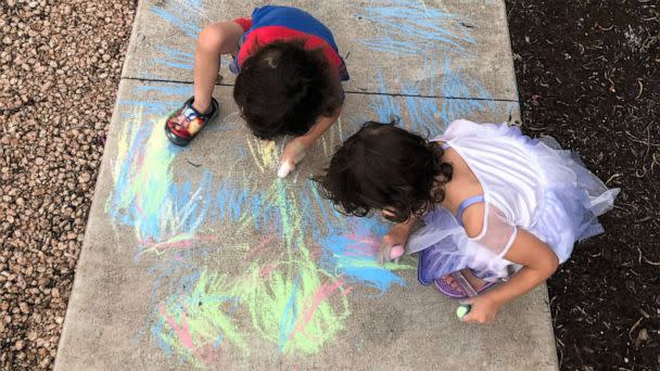 PHOTO: Elsa, a trans girl, can be seen drawing on the sidewalk with her sibling. (Obtained by ABC News)