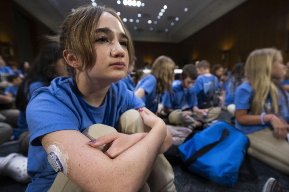 Bay Saunders, 12, with Dexcom G6 patch on her arm for the treatment of her Type 1 diabetes, attends a Senate Appropriations Committee hearing on how the Special Diabetes Program is creating hope for those Living with Type 1 Diabetes, together with other children with Type 1 diabetes, Tuesday, July 11, 2023, in Washington. (AP Photo/Manuel Balce Ceneta)