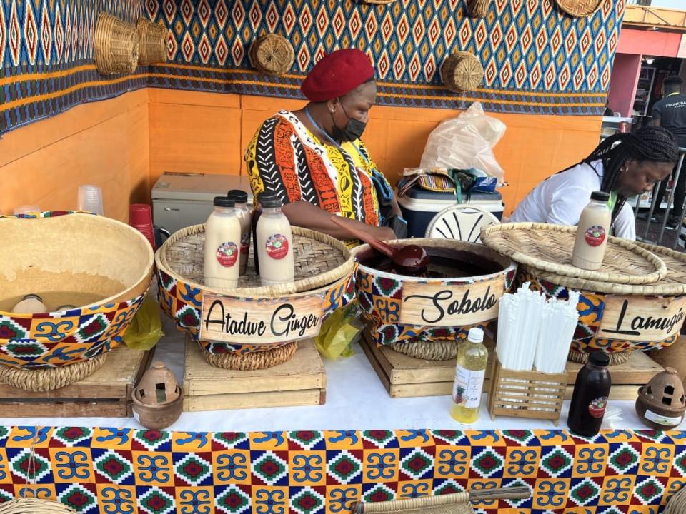 The owner of Eno’s Kitchen, Ewuraewoa Aso, selling locally made beverages at the 2022 Afrochella Festival at El Wak Stadium in the greater Accra region of Ghana on Dec. 28, 2022. (theGrio Photo/Chinekwu Osakwe)