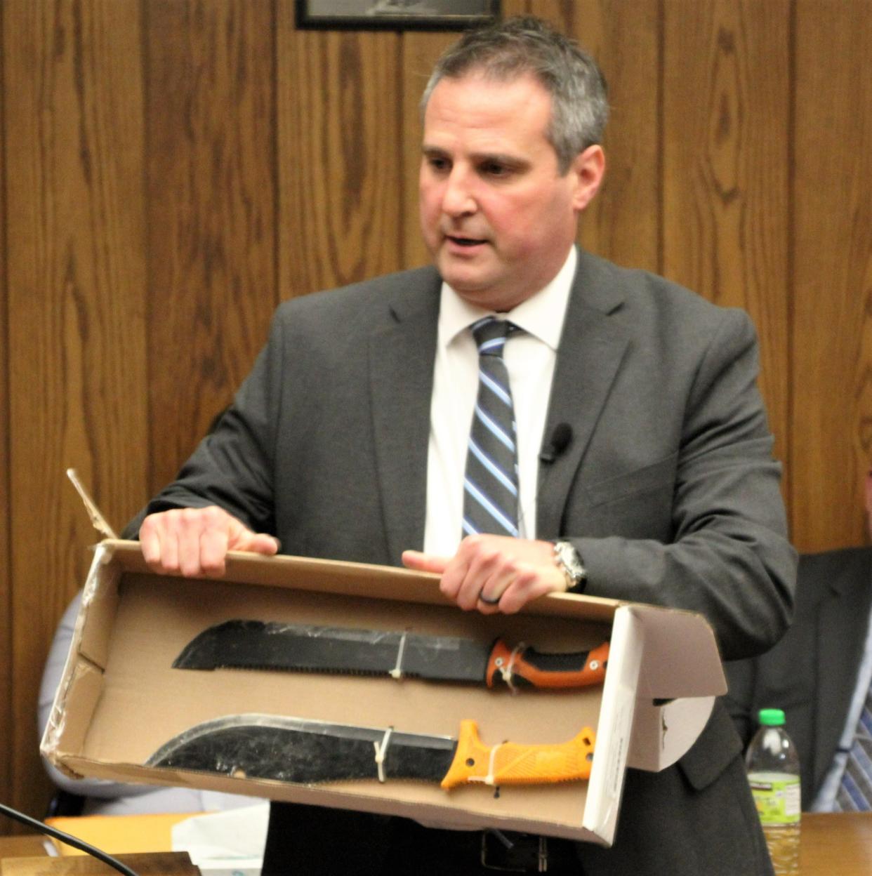 Marion County Prosecutor Ray Grogan displays two machetes found inside a Fies Avenue residence that was the site of a Feb. 12, 2022, incident in which a woman was beaten by her boyfriend. The man also attempted to hit a Marion police officer with a machete.