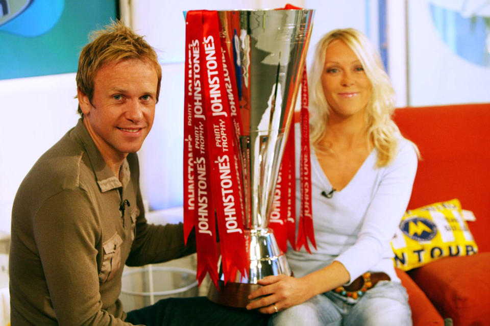 Sky Sports Soccer AM presenters Tim Lovejoy and Helen Chamberlain hold the newly named Johnstone's Paint Trophy ahead of the first round draw.   (Photo by David Parry - PA Images/PA Images via Getty Images)