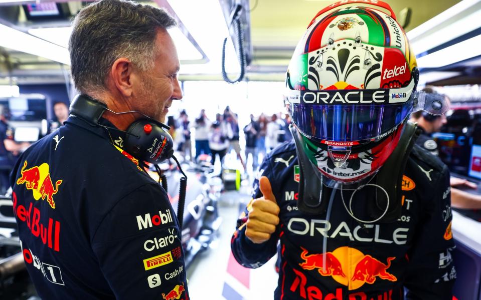 Sergio Perez of Mexico and Oracle Red Bull Racing prepares to drive in the garage next to Red Bull Racing Team Principal Christian Horner prior to the F1 Grand Prix of Mexico at Autodromo Hermanos Rodriguez on October 30, 2022 in Mexico City, Mexic - Mark Thompson/Getty Images