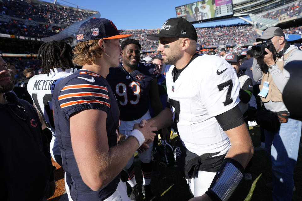 Chicago Bears quarterback Tyson Bagent, left, and Las Vegas Raiders quarterback Brian Hoyer (7) meet on the field after the Bears won an NFL football game Sunday, Oct. 22, 2023, in Chicago. (AP Photo/Charles Rex Arbogast)