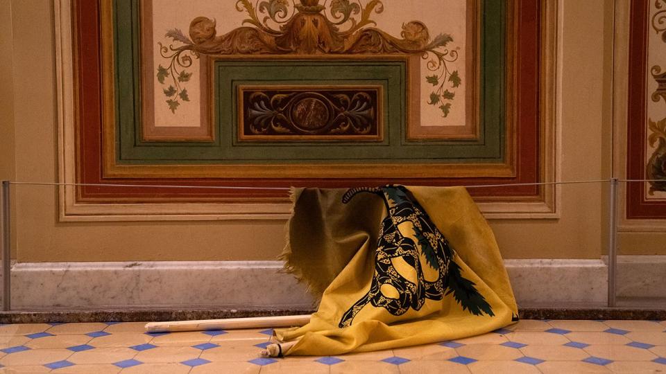 A discarded Gadsden flag inside the U.S. Capitol in Washington D.C., U.S., on Wednesday, Jan. 6, 2021. The House and Senate resumed a politically charged debate over the legitimacy of the presidential election hours after a pro-Trump mob stormed the U.S. Capitol and drove lawmakers from their chambers.