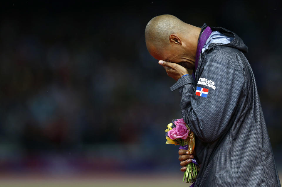 Felix Sanchez of the Dominican Republic cries after receiving his gold medal during the men's 400m hurdles victory ceremony at the London 2012 Olympic Games at the Olympic Stadium August 6, 2012. (REUTERS/Eddie Keogh)