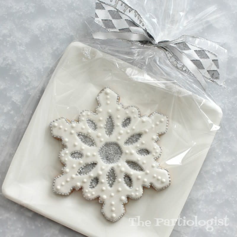 <p>The Partiologist</p><p>A snowflake cookie gets an elegant touch with white and silver icing.</p><p><strong>Get the recipe: <a href="https://www.thepartiologist.com/2019/07/christmas-cookies-in-july.html" rel="nofollow noopener" target="_blank" data-ylk="slk:Jumbo Snowflake Cookie;elm:context_link;itc:0;sec:content-canvas" class="link rapid-noclick-resp">Jumbo Snowflake Cookie</a></strong></p>