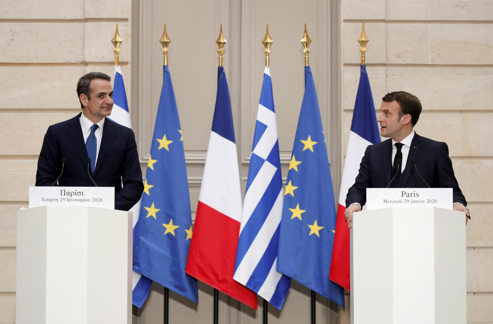 French President Emmanuel Macron, right, and Greek Prime Minister Kyriakos Mitsotakis attend a joint press conference at the Elysee Palace in Paris, Wednesday Jan. 29, 2020. (Benoit Tessier/Pool via AP)