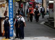 Police officers wearing protective face masks are seen as the spread of the coronavirus disease (COVID-19) continues, in Tokyo